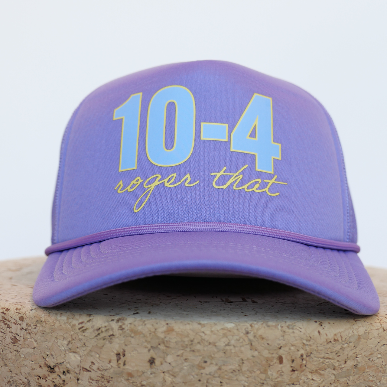 Purple cap with '10-4 roger that' text on a light background