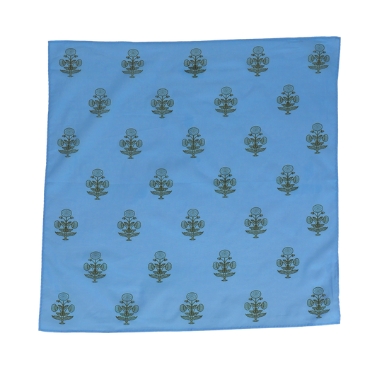 Blue fabric with green floral patterns on a white background